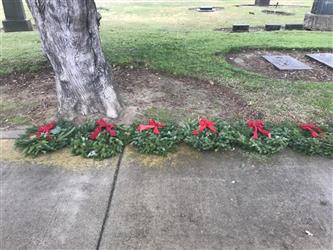laying wreathes on headstones